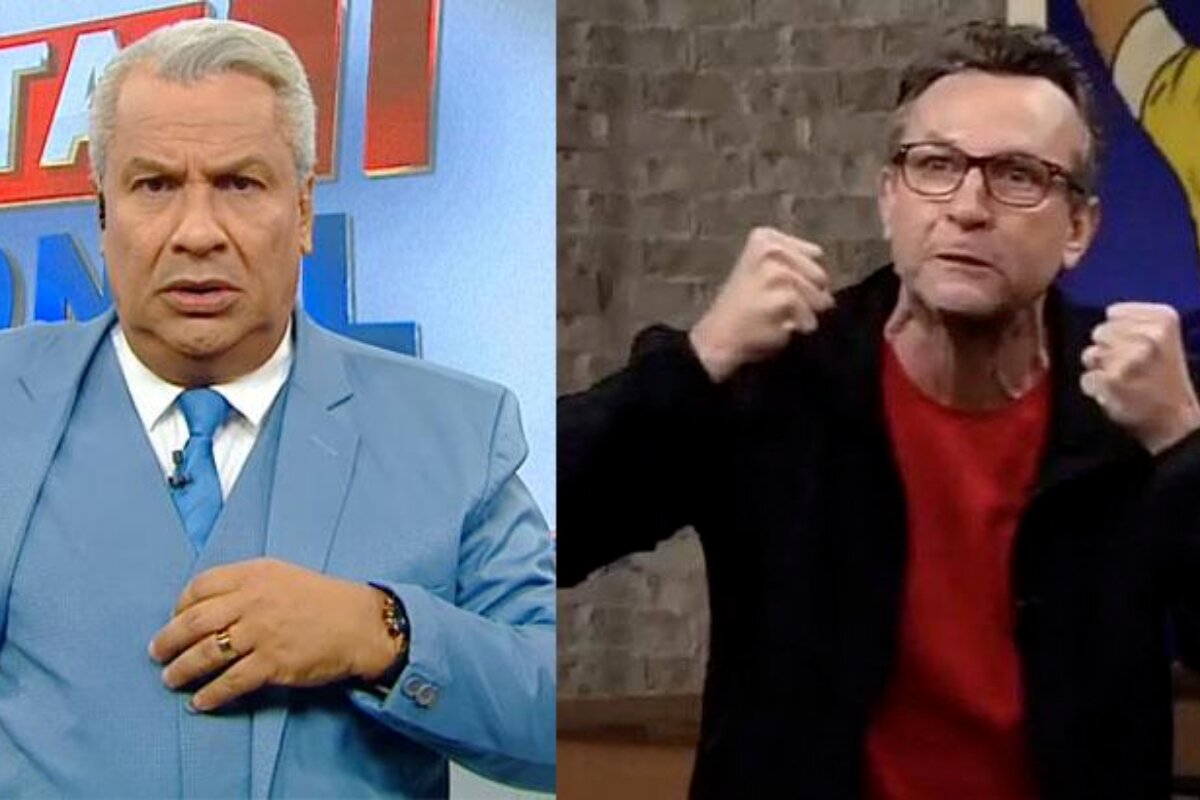 Sikêra Júnior de terno azul claro - Neto com os punhos cerrados, de blazer preto, camisa vermelha, óculos