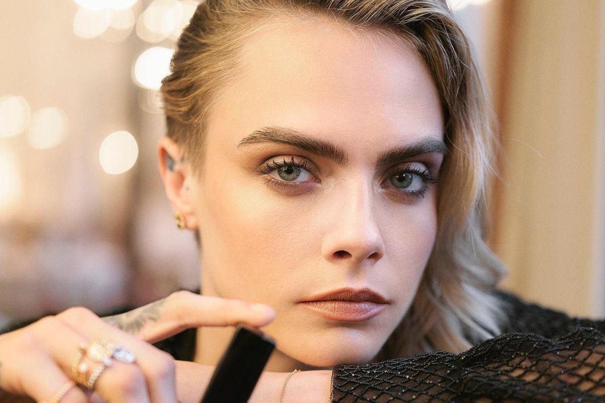 cara delevingne posando estilosa com look preto e maquiagem