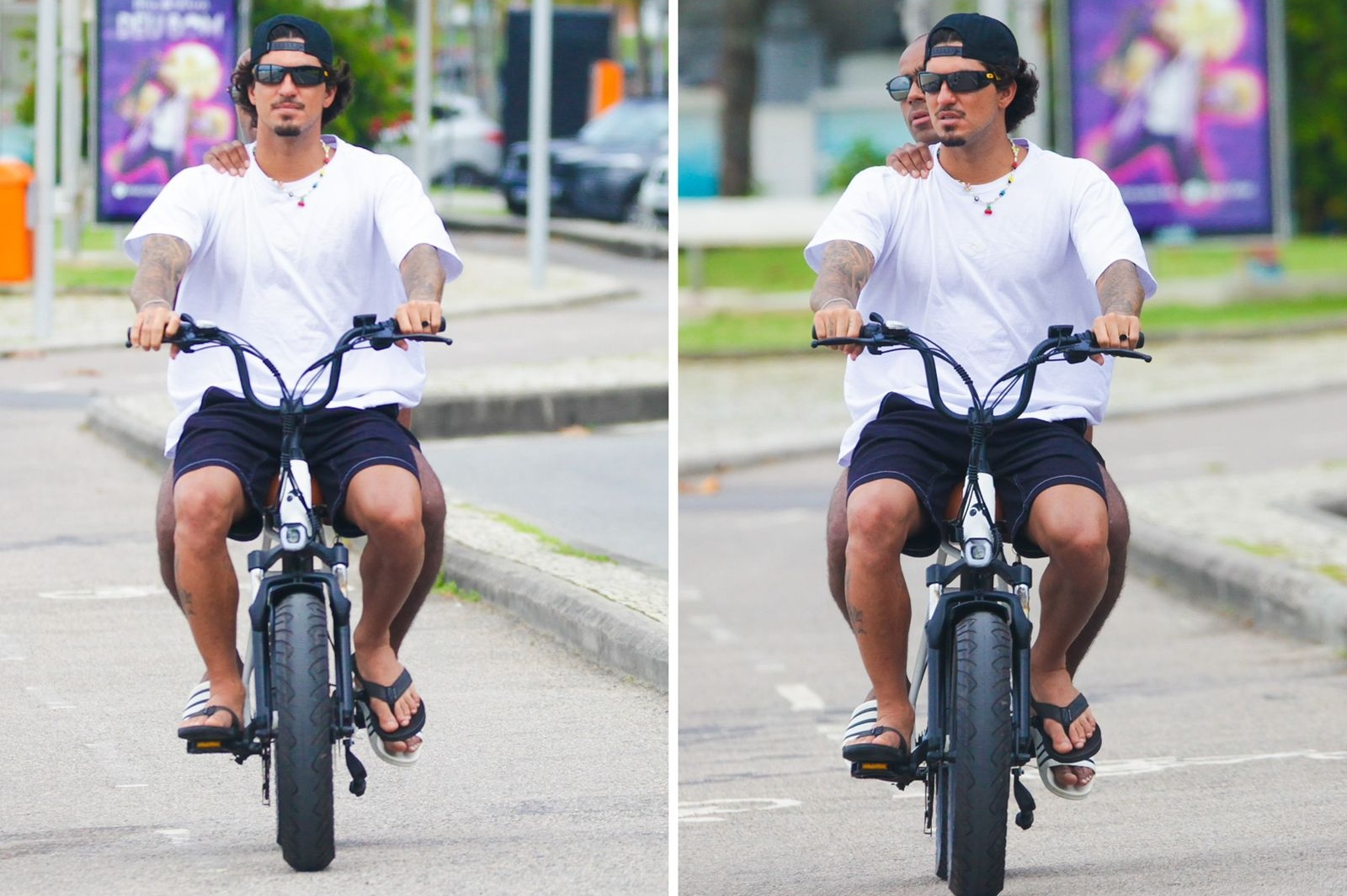 Gabriel Medina de bike na orla, de camisa branca e bermuda preta, com amigo na garupa