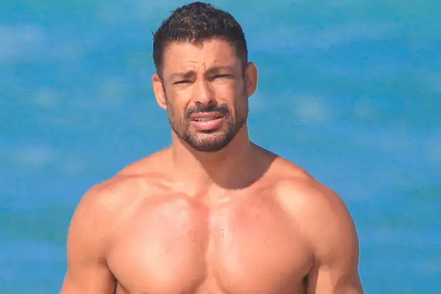 Cauã Reymond sem camisa na praia da Barra da Tijuca